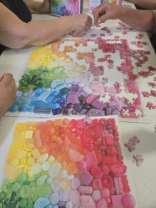 People putting together jigsaw puzzle. 