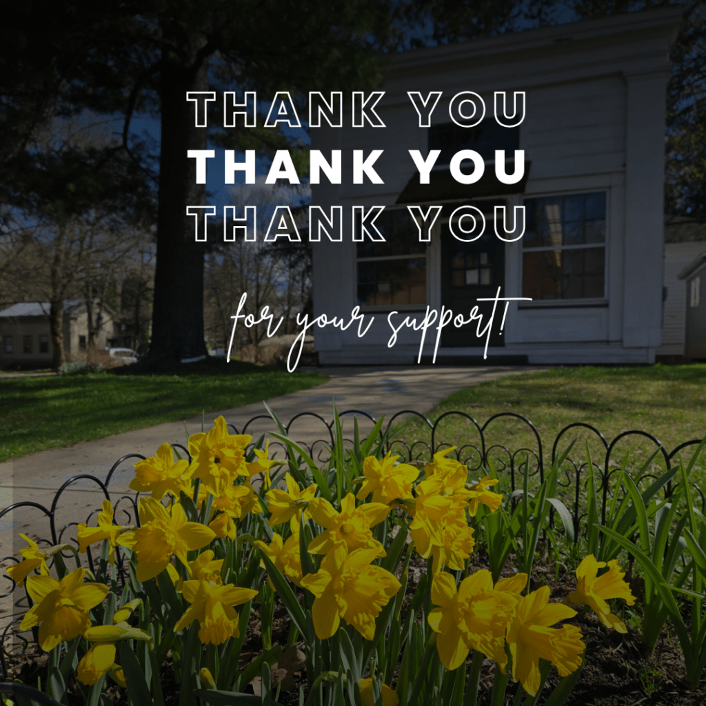 picture of daffodils in front of library.